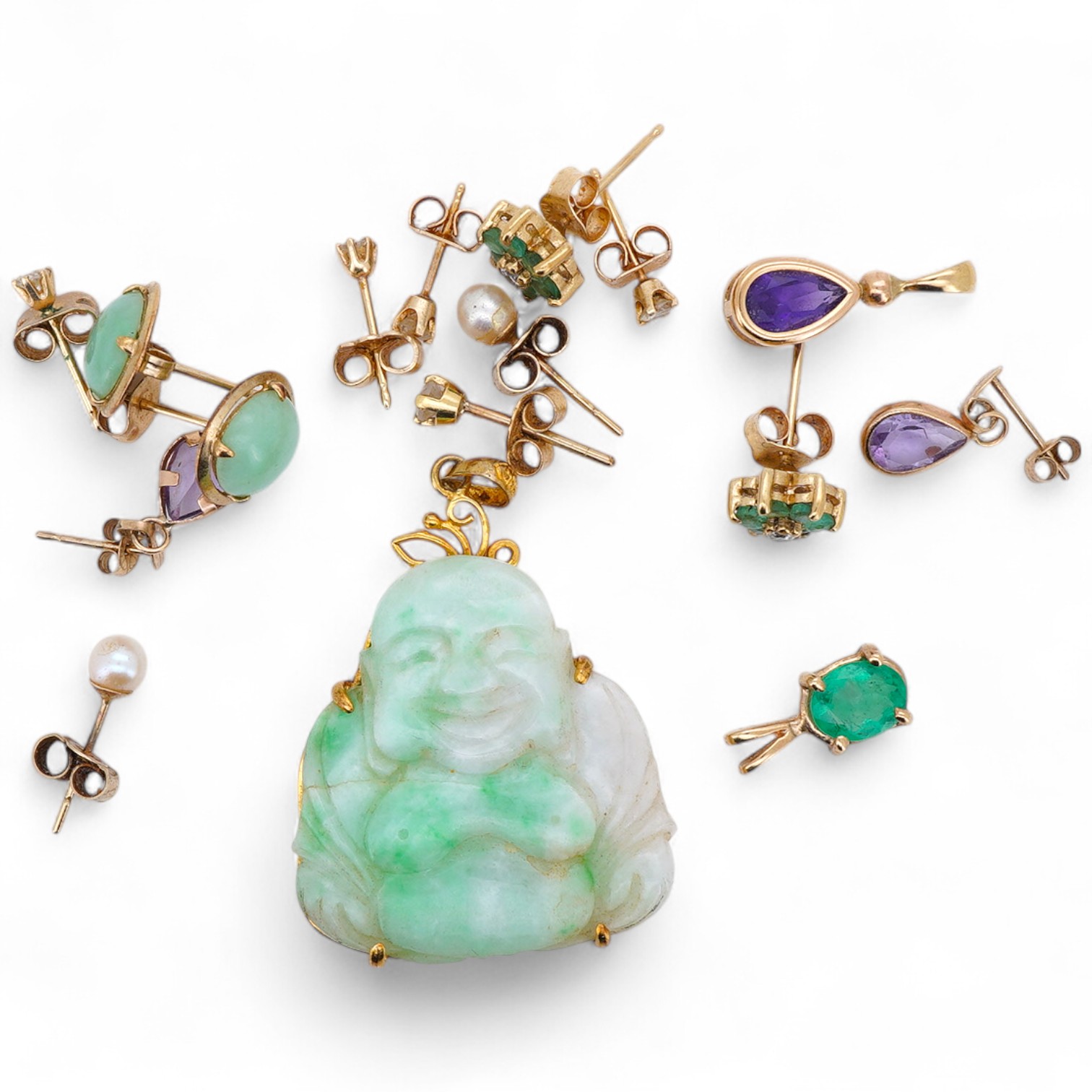 A collection of earrings and two pendants, comprising: two pairs and one single diamond studs, each set with a brilliant-cut diamond weighing approximately 0.07 carats; a pair of emerald and diamond cluster stud earrings